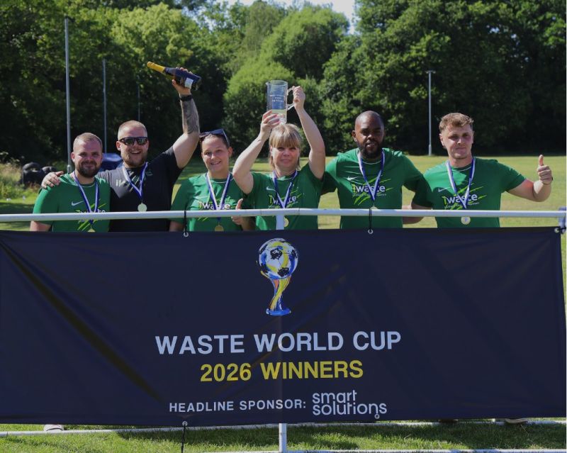 iWaste lifting the Jug trophy under the Waste World Cup 2026 Winners banner